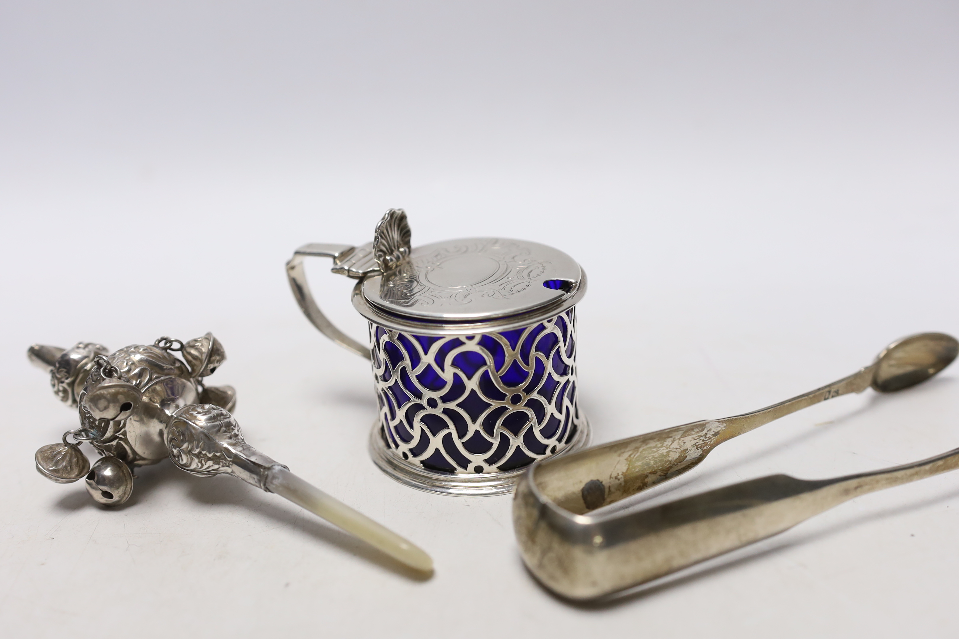 A Victorian pierced silver drum mustard pot, Charles & George Fox, London, 1854, a pair of 19th century Scottish provincial silver fiddle pattern sugar tongs, by David Gray of Dumfries, circa 1825 and a mother of pearl m